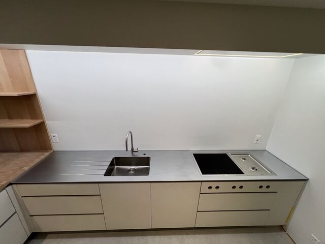 Plan de travail inox dans une cuisine claire